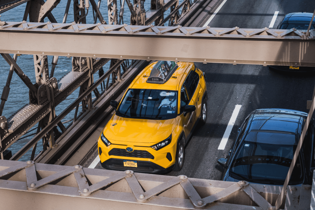 SUV taxi driving on a bridge